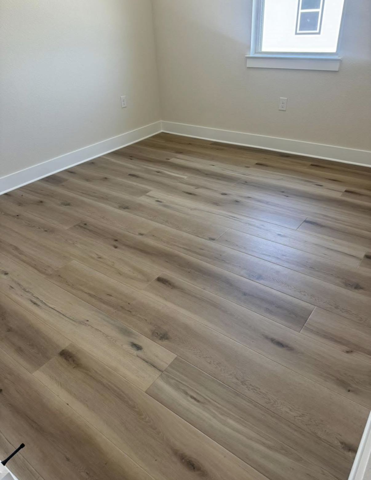 High-end hardwood flooring with exposed beam ceiling in Austin home